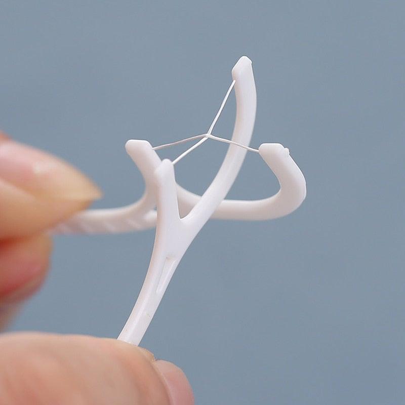 Palillos para usar hilo dental